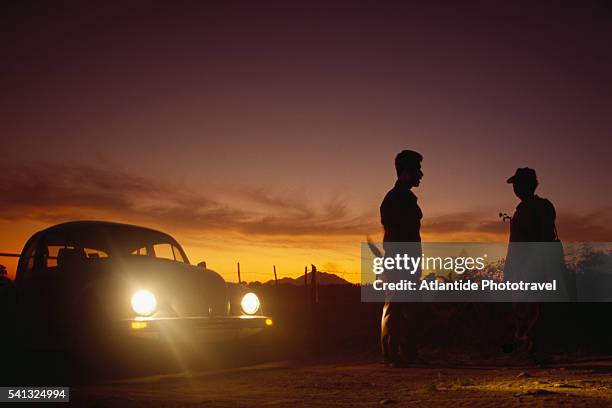 men standing in headlights - vw beetle stock pictures, royalty-free photos & images