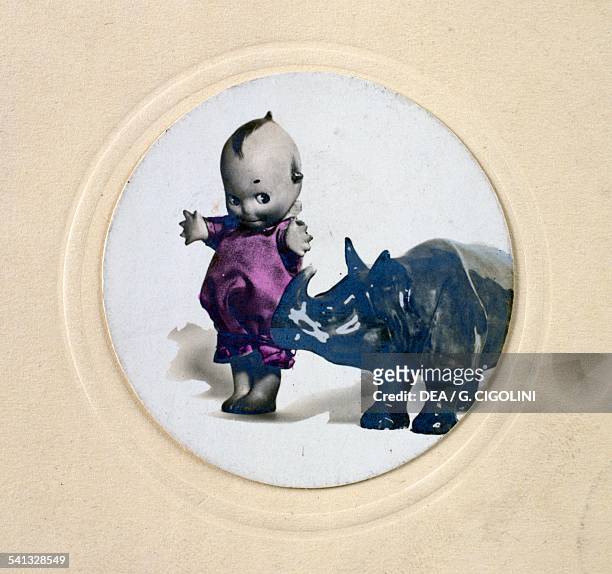 Kewpie doll with rhinoceros, postcard, 1930s. United States of America, 20th century.