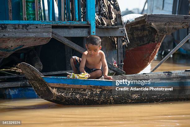 kid playing on a boat on the mekong river - chau doc stock pictures, royalty-free photos & images