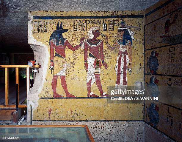 Tutankhamun flanked by god Anubis and goddess Hathor, Hathor offering him life with the ankh, Tomb of Tutankhamun, Valley of the Kings, Ancient...