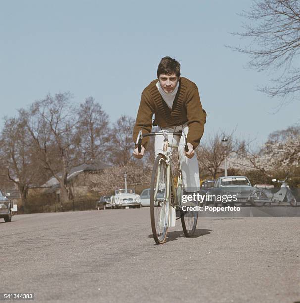 English actor Alan Bates who appears in the film, 'Far From the Madding Crowd' pictured cycling on a road in London in 1967.