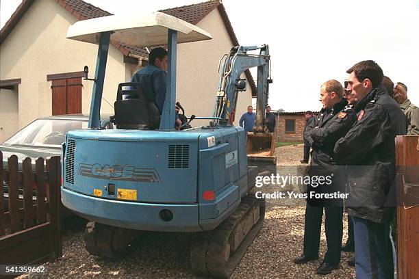 Mechanical digger will dig up the garden after two bodies were discovered on the premises.