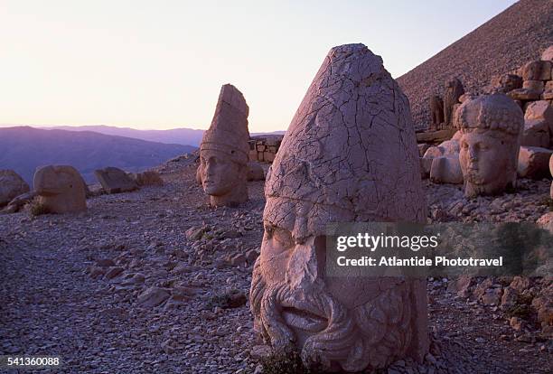 colossal heads at west terrace of hierothesion of antiochus i - zeus stock pictures, royalty-free photos & images