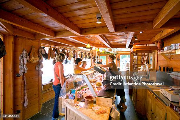 brisk business at mason du jambon (house of ham) - la clusaz stock pictures, royalty-free photos & images