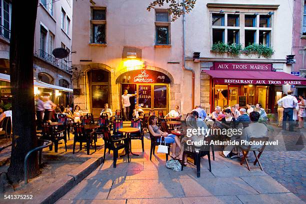 people relaxing at outdoor cafe in place du government - lyon restaurants stock pictures, royalty-free photos & images