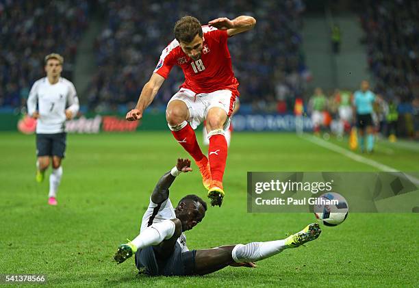 Admir Mehmedi of Switzerland is tackled by Bacary Sagna of France during the UEFA EURO 2016 Group A match between Switzerland and France at Stade...