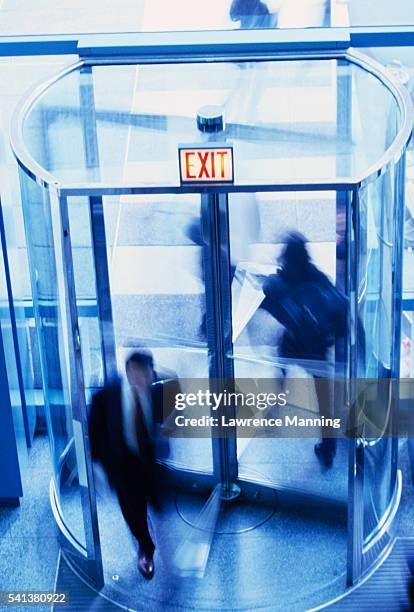 people going through revolving door - revolve stock pictures, royalty-free photos & images