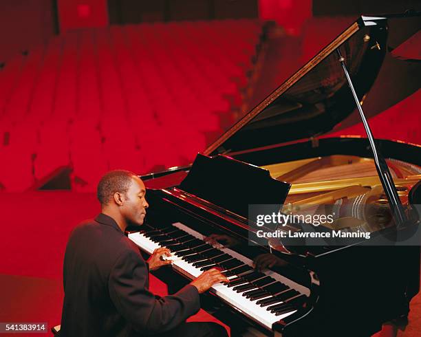 man playing a piano - pianist foto e immagini stock