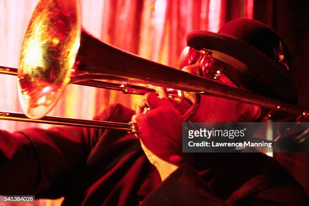 trombonist playing at a nightclub - salsa dancing stockfoto's en -beelden