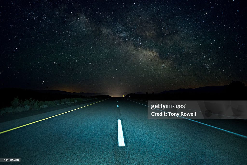 The Milky Way rises over a remote section of Highway 395 in California's Eastern Sierra