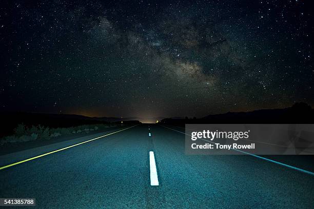 the milky way rises over a remote section of highway 395 in california's eastern sierra - roads imagens e fotografias de stock