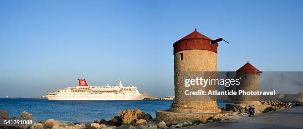 ancient windmills with passing cruise ship - cruise and motorbike and ship stock-fotos und bilder