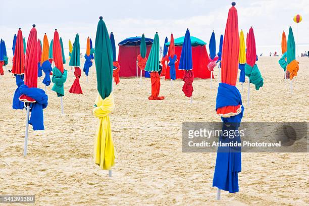 closed beach umbrellas - deauville beach stock pictures, royalty-free photos & images