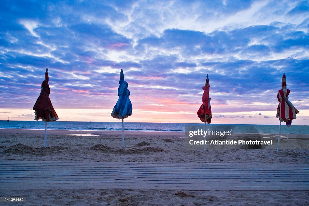 Closed Beach Umbrellas at Sunset