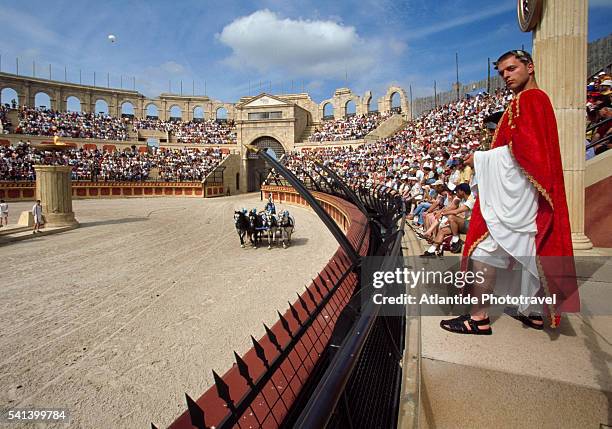 performer in costume during chariot race at puy du fou - fou stock pictures, royalty-free photos & images