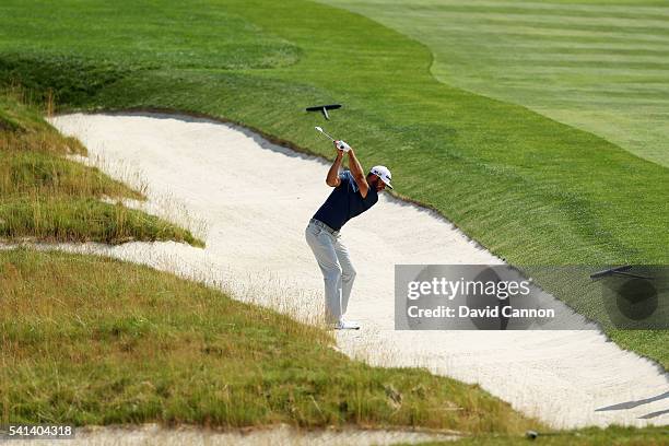 Dustin Johnson of the United States plays a shot from the church pew bunker on the fourth hole during the final round of the U.S. Open at Oakmont...