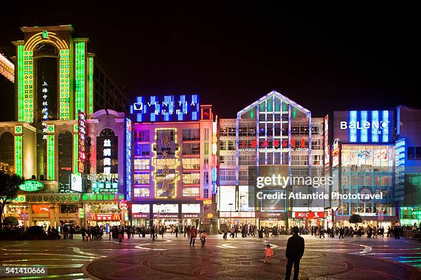 neon lights up nanjing road at night - nanjing road stock pictures, royalty-free photos & images