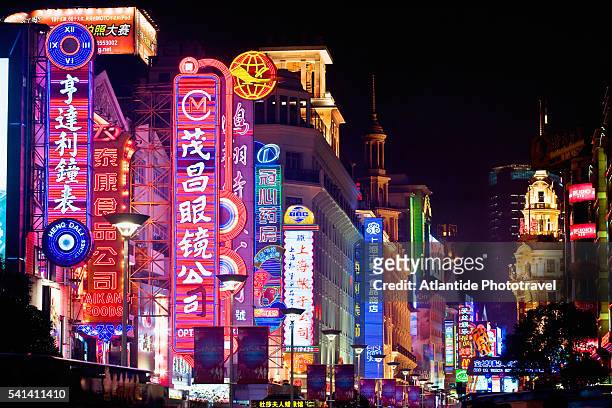 neon signs on nanjing road in shanghai - shanghai stock pictures, royalty-free photos & images