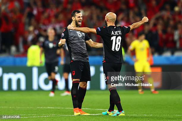 Mergim Mavraj and Arlind Ajeti of Albania celebrate their 1-0 win in the UEFA EURO 2016 Group A match between Romania and Albania at Stade des...