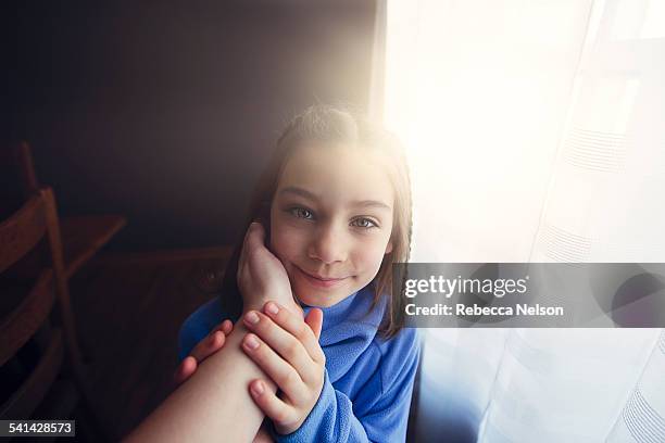 mother cupping daughter's chin - hazel bond stock pictures, royalty-free photos & images