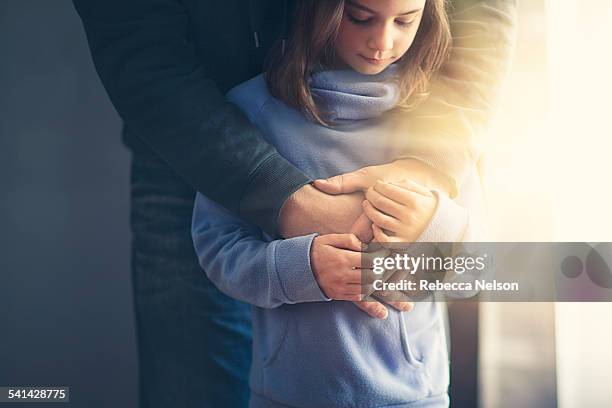 father's arms wrapped around daughter