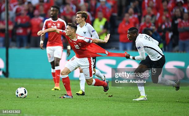 Paul Pogba of France in action against Granit Xhaka of Switzerland during the UEFA EURO 2016 Group A match between Switzerland and France at Stade...