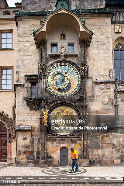 street sweeper in front of the astronomical clock on old town hall, prague, czech republic - prague clock stock pictures, royalty-free photos & images