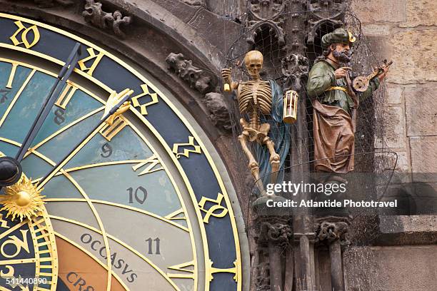 sculptures beside the face of the astronomical clock on old town hall, prague, czech republic - prague clock stock pictures, royalty-free photos & images