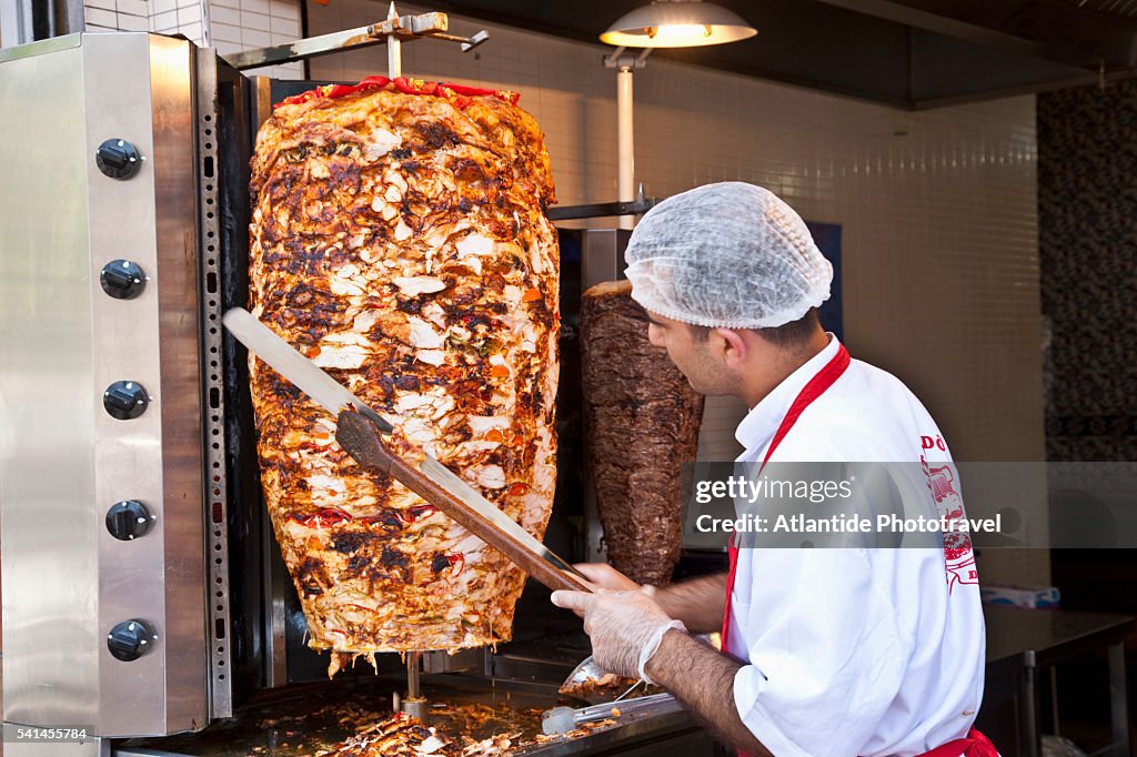 Kebab vendor slicing meat
