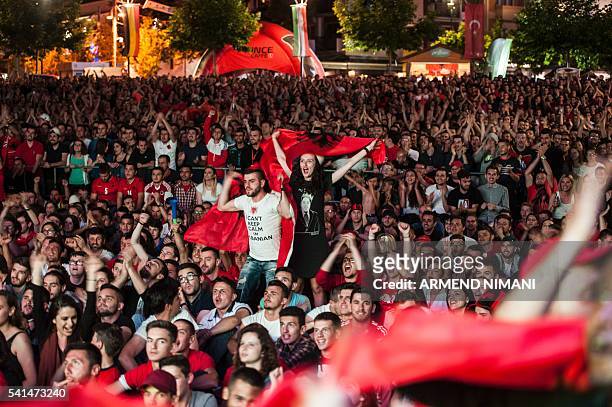 Albania's supporters celebrate the win of Albania as they watch on a big screen the Euro 2016 group A football match between Romania and Albania at...