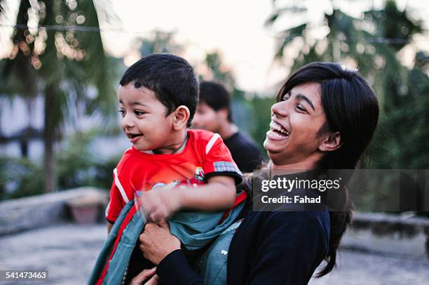 sibling looking at something and laughing - bangladesch stock-fotos und bilder