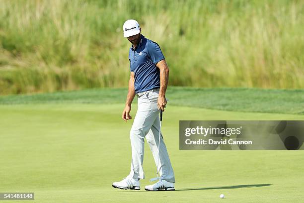 Dustin Johnson of the United States watches a putt on the fifth green during the final round of the U.S. Open at Oakmont Country Club on June 19,...