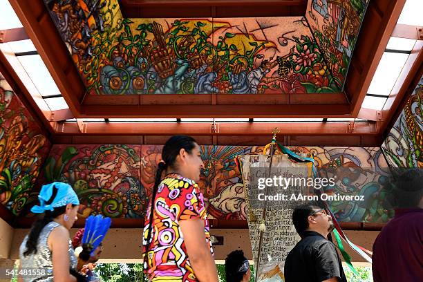 Mural by David Ocelotl is displayed overhead as he and other dignitaries speak during a mural dedication at La Raza Park on Sunday, June 20, 2016....