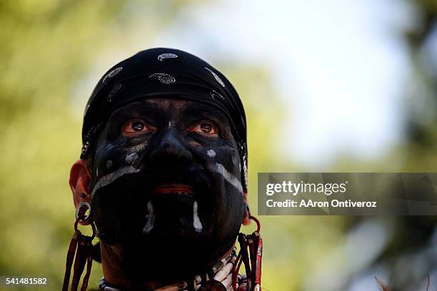 Robert Amaya stands in the shade after dancing during a mural dedication at La Raza Park on Sunday, June 20, 2016. The Denver Arts and Venue' public...