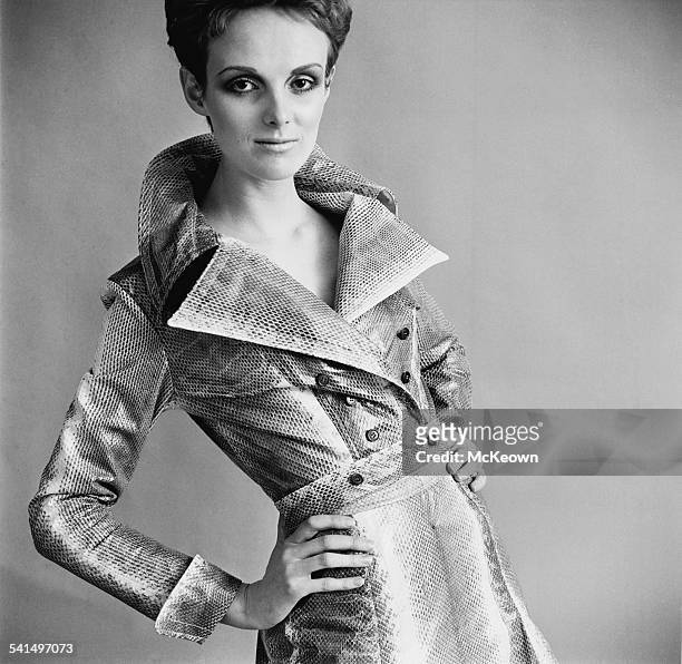 British model Grace Coddington showing a double breasted faux snakeskin raincoat, 18th April 1967.