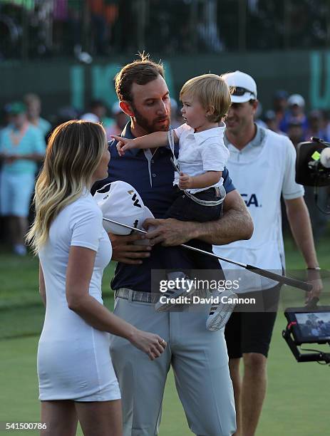 Dustin Johnson of the United States celebrates with partner Paulina Gretzky and son Tatum after winning the U.S. Open at Oakmont Country Club on June...