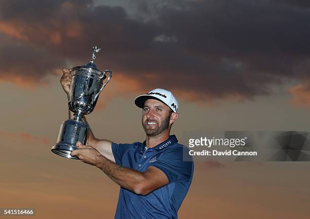 Dustin Johnson of the United States poses with the winner's trophy after winning the U.S. Open at Oakmont Country Club on June 19, 2016 in Oakmont,...