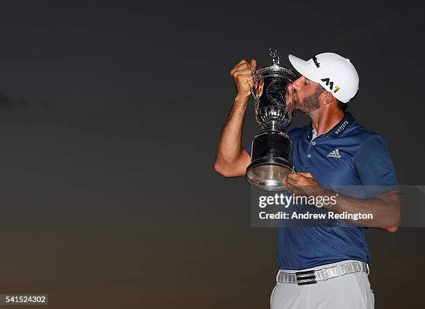 Dustin Johnson of the United States kisses the winner's trophy after his victory at the U.S. Open at Oakmont Country Club on June 19, 2016 in...