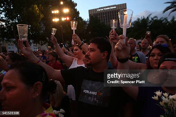 People attend a memorial service on June 19, 2016 in Orlando, Florida. Thousands of people are expected at the evening event which will feature...