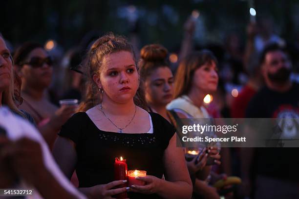 People attend a memorial service on June 19, 2016 in Orlando, Florida. Thousands of people are expected at the evening event which will feature...