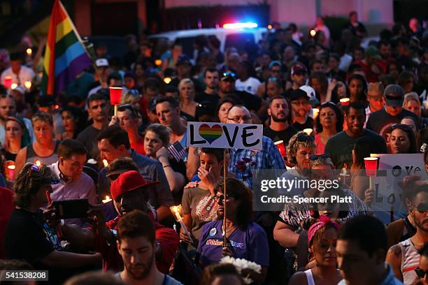 People attend a memorial service on June 19, 2016 in Orlando, Florida. Thousands of people are expected at the evening event which will feature...