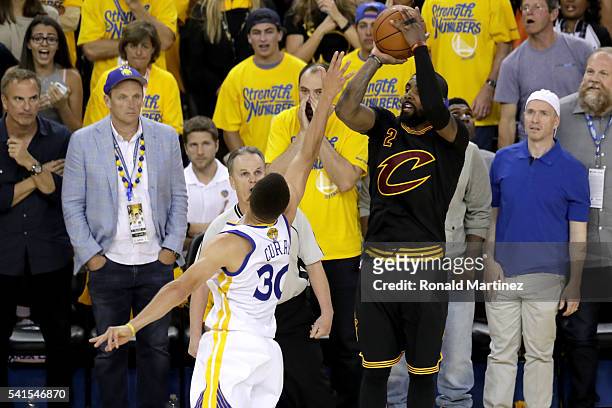 Kyrie Irving of the Cleveland Cavaliers shoots a three-point basket against the Golden State Warriors in Game 7 of the 2016 NBA Finals at ORACLE...