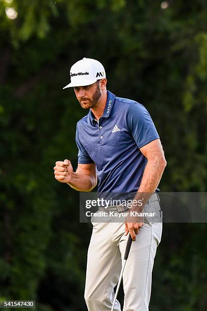 Dustin Johnson celebrates and pumps his fist after making a par putt on the 16th hole green during the final round of the U.S. Open at Oakmont...