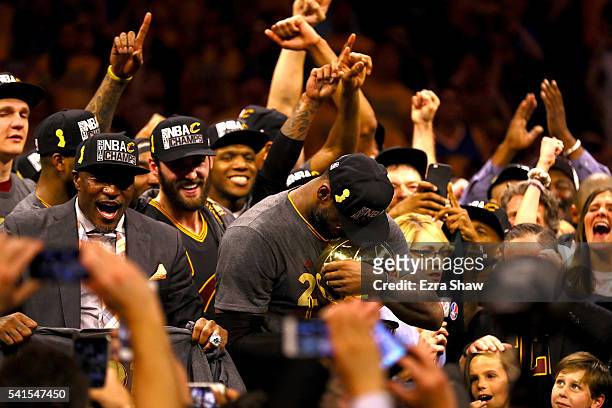 LeBron James of the Cleveland Cavaliers holds the Larry O'Brien Championship Trophy after defeating the Golden State Warriors 93-89 in Game 7 of the...
