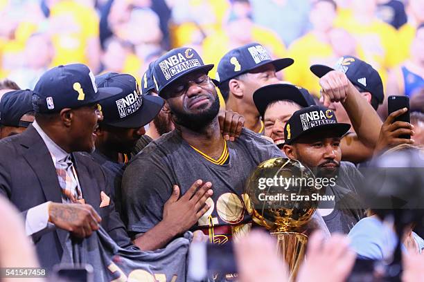 LeBron James of the Cleveland Cavaliers holds the Larry O'Brien Championship Trophy after defeating the Golden State Warriors 93-89 in Game 7 of the...