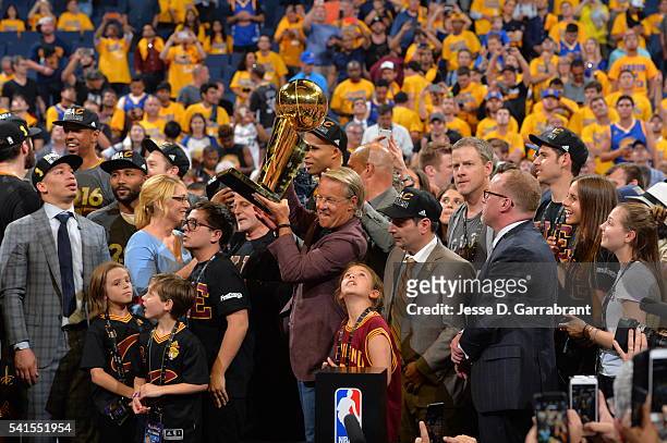 Owner Dan Gilbert of the Cleveland Cavaliers accepts the NBA championship trophy against the Golden State Warriors during the 2016 NBA Finals Game...