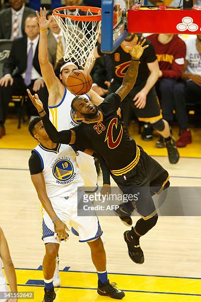 Cleveland Cavaliers forward LeBron James is fouled by Golden State Warriors center Anderson Varejao during the first quarter in Game 7 of the NBA...