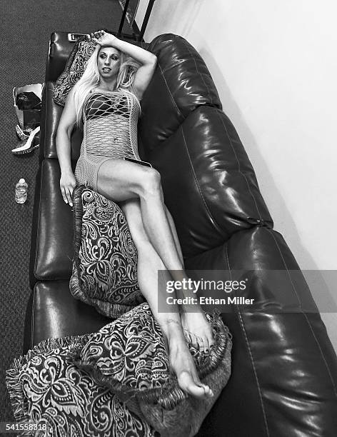 Lingerie Fighting Championships champion Feather "The Hammer" Hadden relaxes on a couch backstage before her match against Allie "Babydoll" Parks...