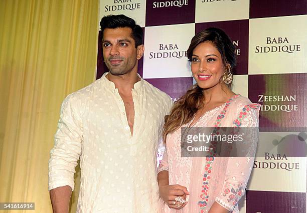 Indian Bollywood actors Bipasha Basu and husband Karan Singh Grover attend an Iftar party hosted by politician Baba Siddiqui during the Islamic holy...