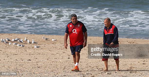 Eddie Jones, the England head coach walks on the beach with skills coach Glen Ella during the England recovery session held at Coogee Beach on June...
